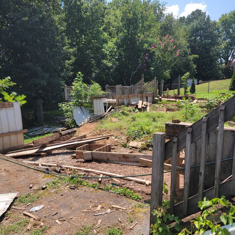Deck demolition in progress with boards pulled up