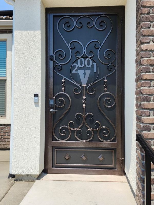 Custom iron entry door with house numbers by J&C Fencing