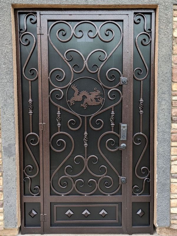Custom wrought iron security door with scrollwork by J&C Fencing