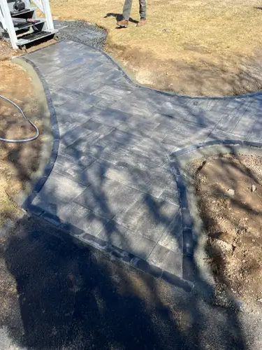 "Curved Elegance: Unilock Beacon Hill Patio Transformation in Charlestown"