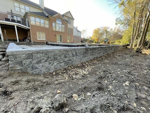 Stunning Retaining Wall Installation for Enhanced Poolside Beauty