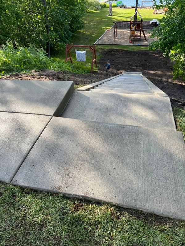 Stepping into Serenity: Waterfront Concrete Steps Masterpiece in Pequot Lakes by Divine Designs