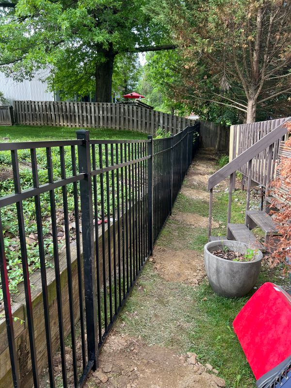 Elegant Black Aluminum Fencing Installation in Lush Green Backyard