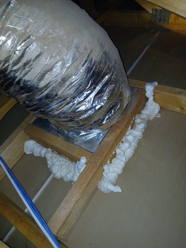 Foam sealing top plate gaps next to ductwork in a Phoenix attic