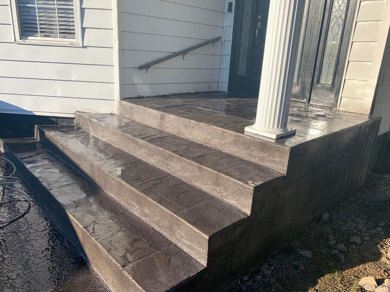 Stamped concrete steps leading to a front porch