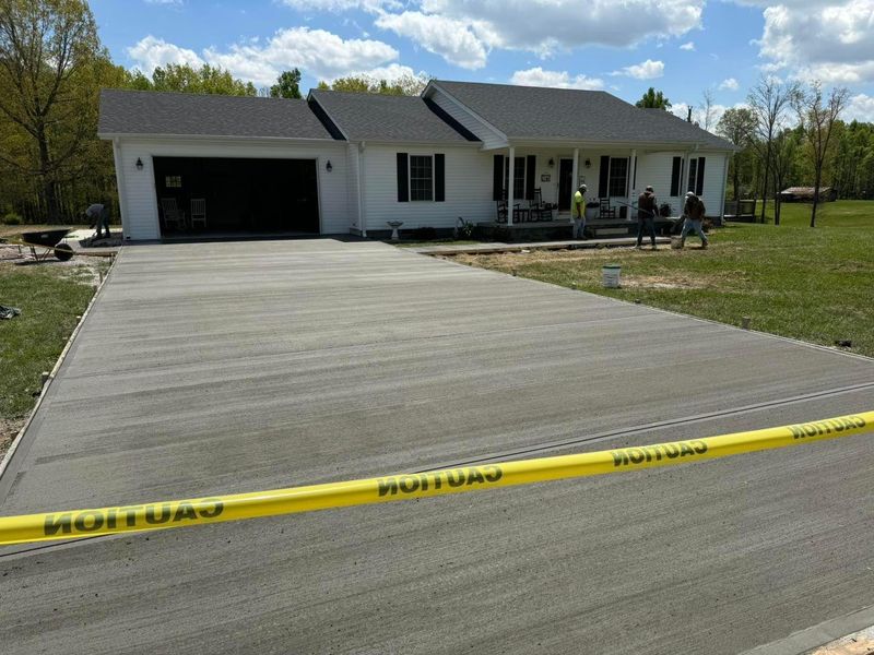 Concrete driveway poured up to a ranch house garage