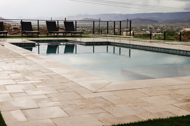 Travertine pool deck with mountain and valley views