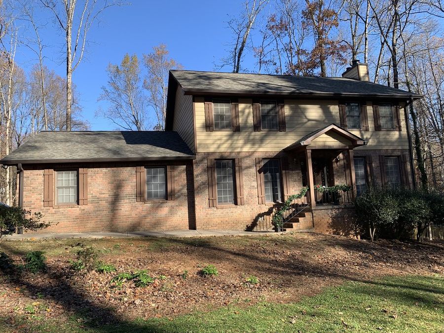 Wooded lot two-story with a new roof