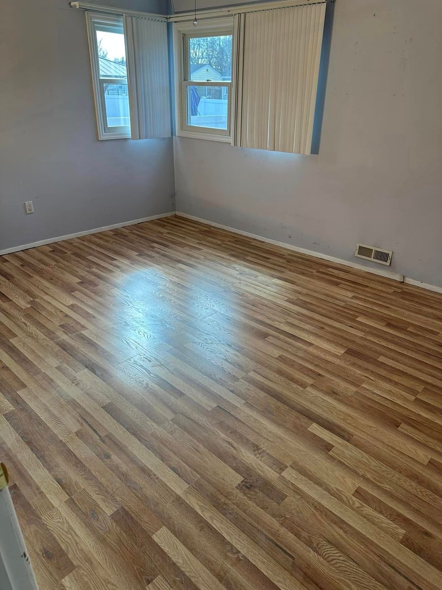 Refinished hardwood floor in an empty bedroom