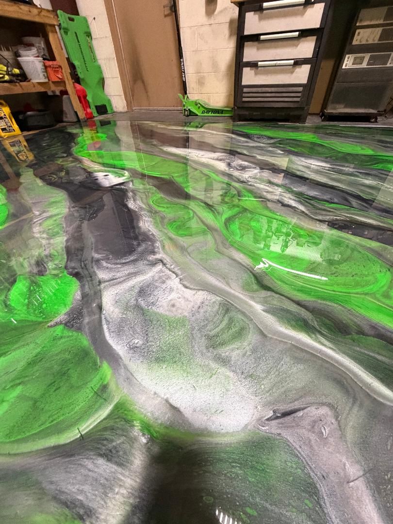 Green and gray metallic epoxy floor in a home garage