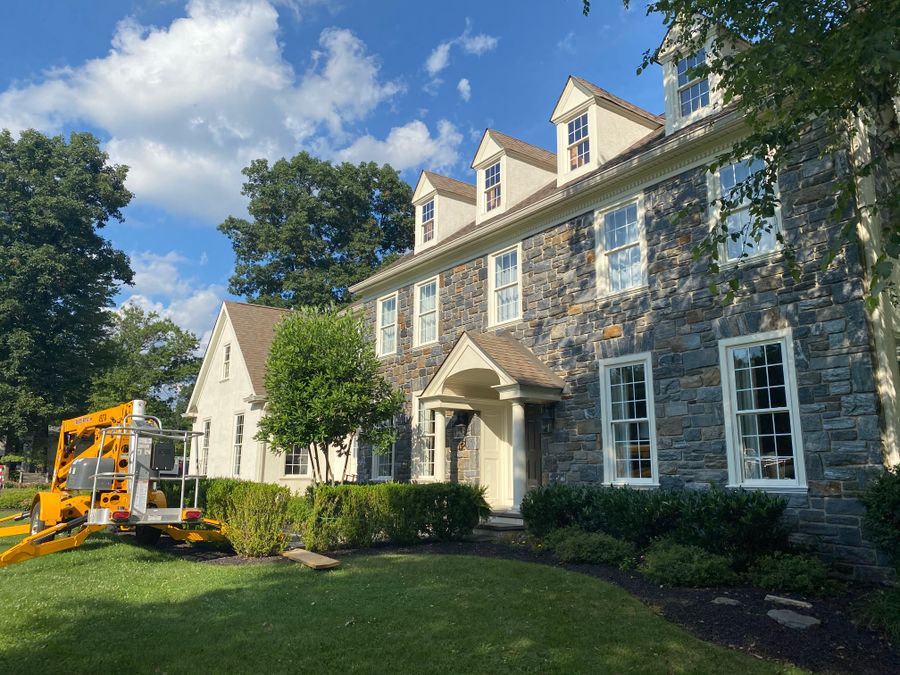 Stone farmhouse with painted trim and porch