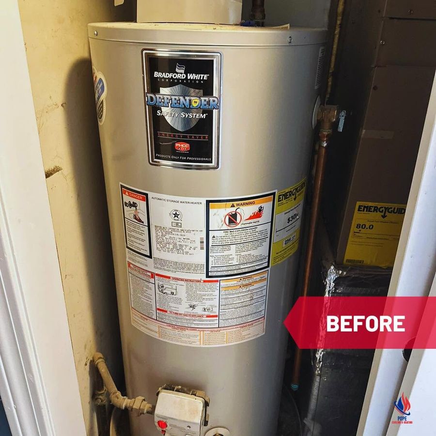 The existing storage water heater before replacement, a floor-standing tank in a closet, tagged BEFORE