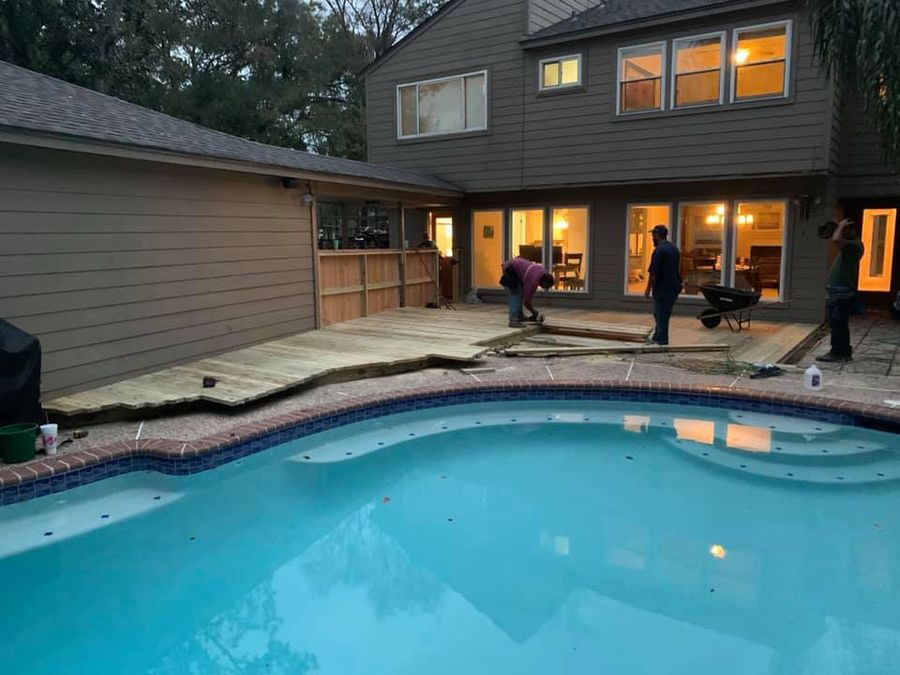 Pool Services by BJR Construction in Fulshear and Katy, TX: crew working on the deck around a backyard pool