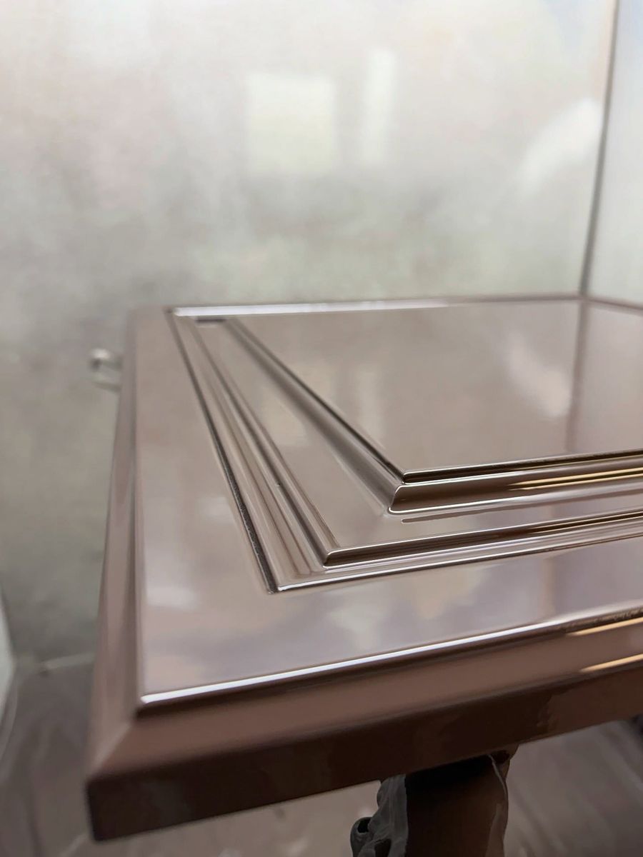 Close-up of a cabinet door with a mirror-like gloss