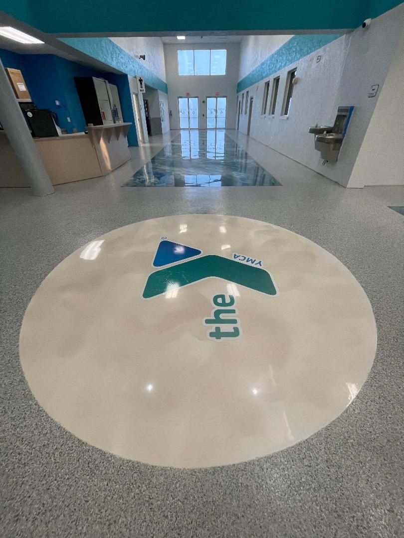 YMCA lobby with the Y logo set into an epoxy floor