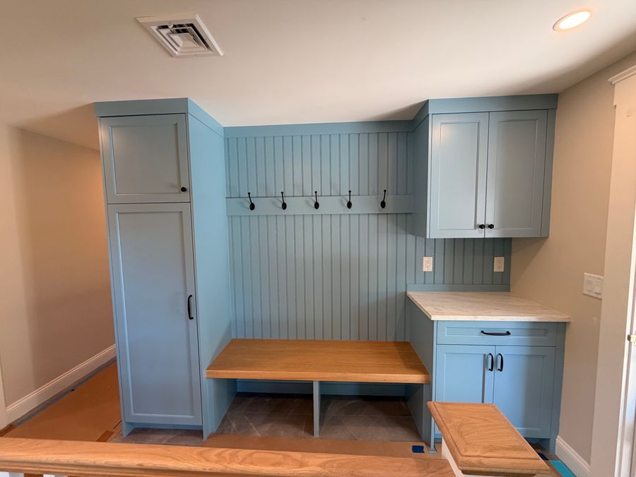 Mudroom built-ins painted blue with a wood bench