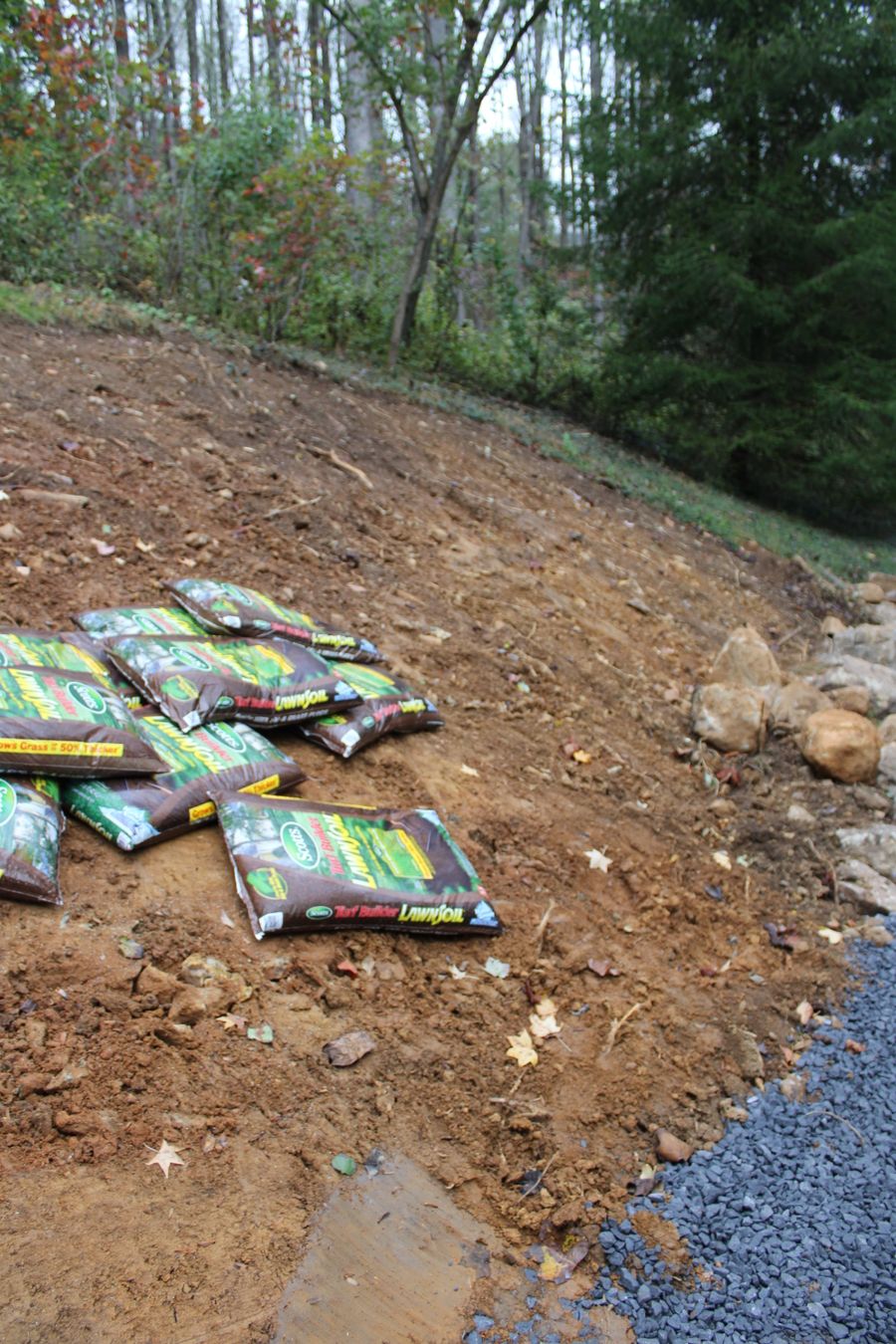 Slope being stabilized with stone and bags