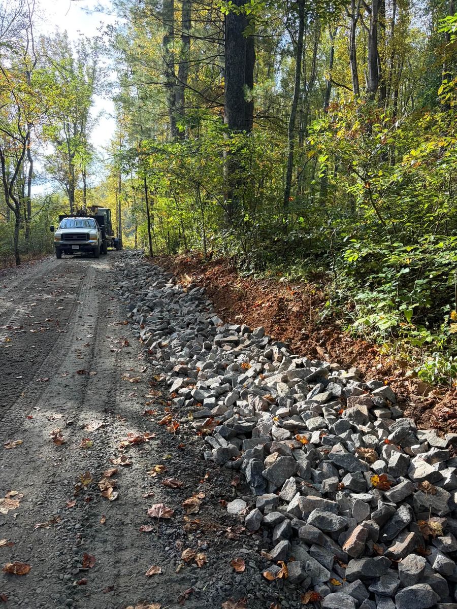 Rock-lined drainage channel beside a driveway