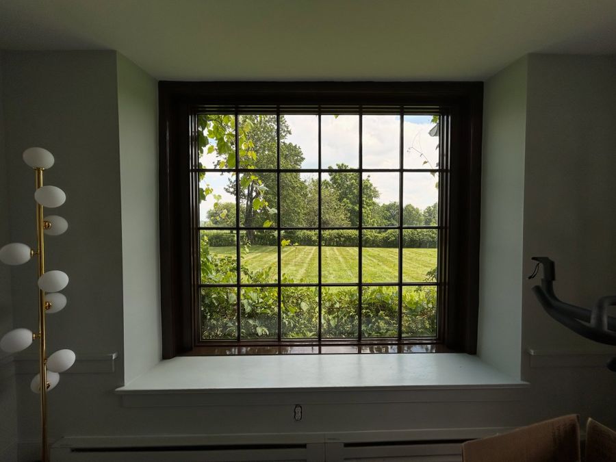Deep window well in a restored farmhouse