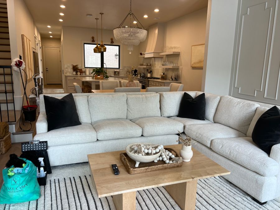 Living room with a white sectional after a clean