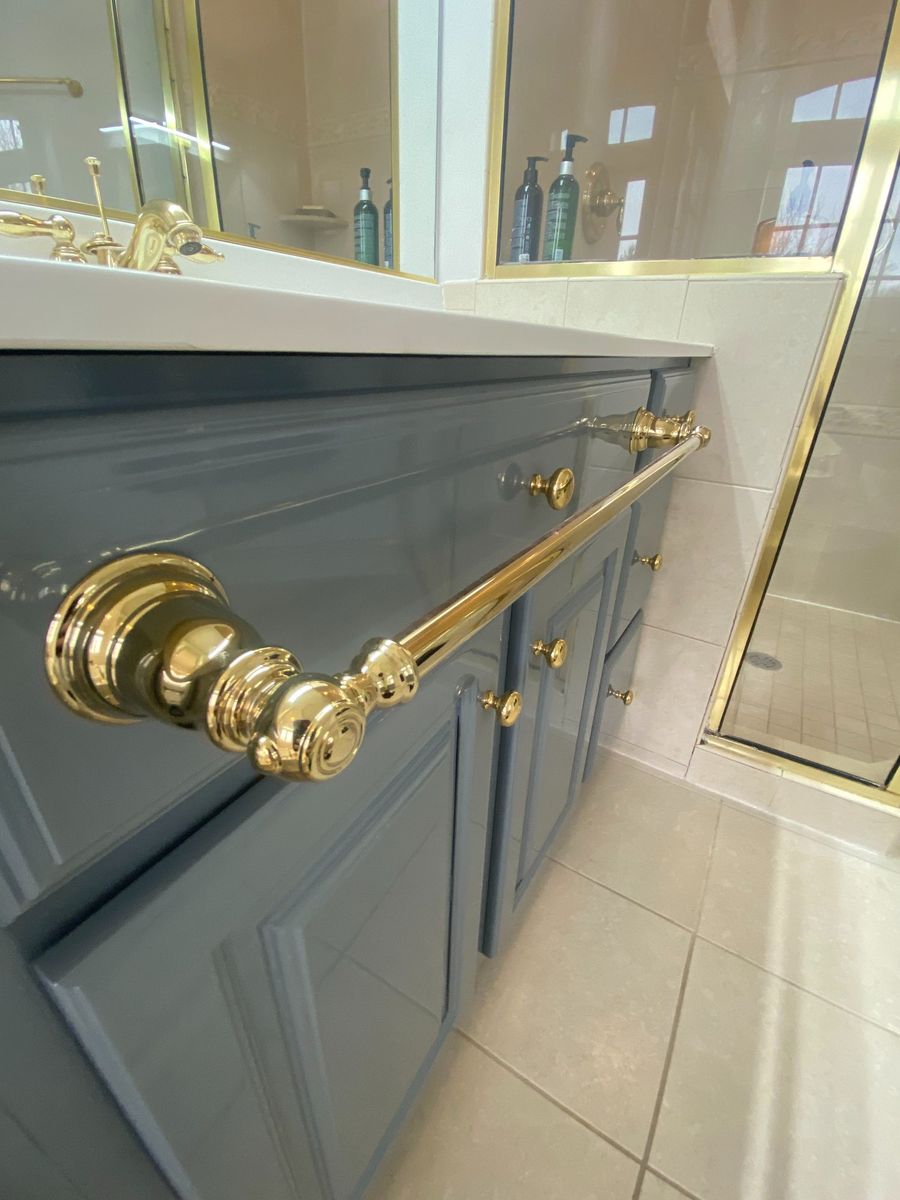Gloss-finished vanity with brass towel bar
