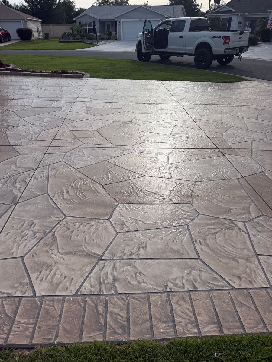 Large flagstone overlay driveway with a border band