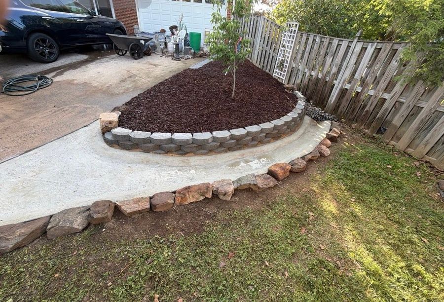 Curved block retaining wall holding a raised mulched bed