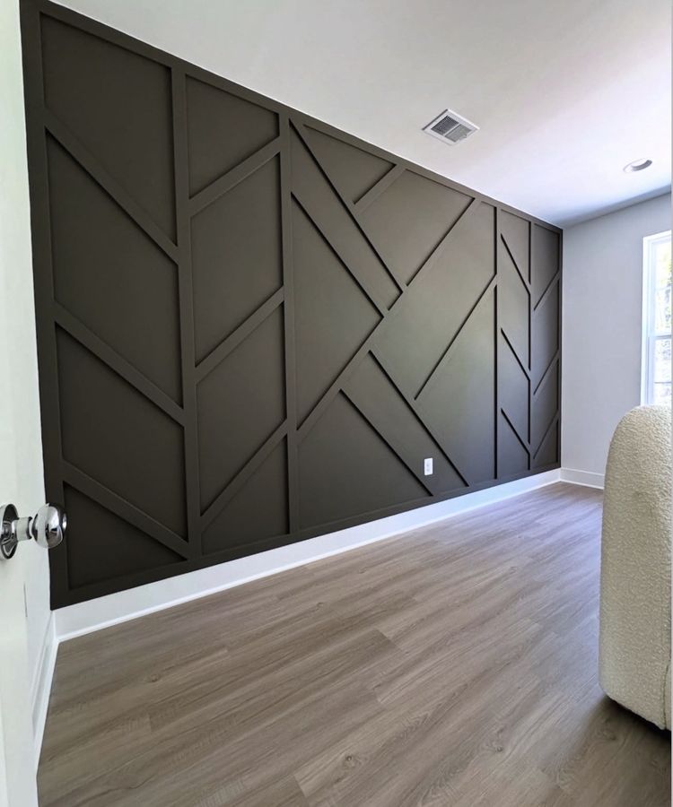 Dark geometric accent wall in a finished bedroom