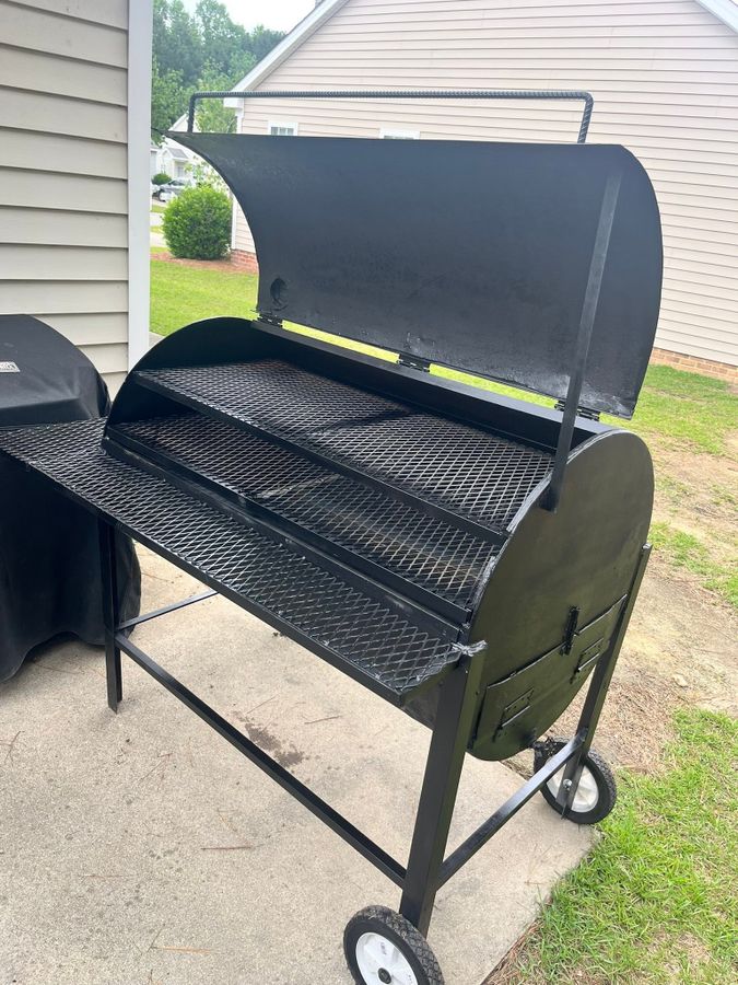 Custom pig cooker on wheels with the lid open