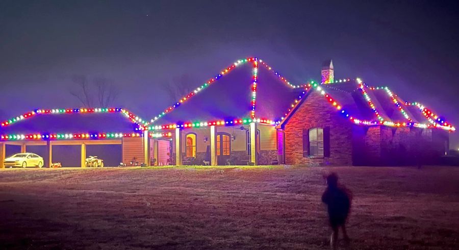 Multicolor roofline lights on a brick home in Shreveport