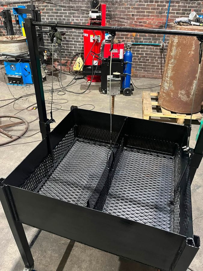 Custom-built cooker box with grates and a hanging bar