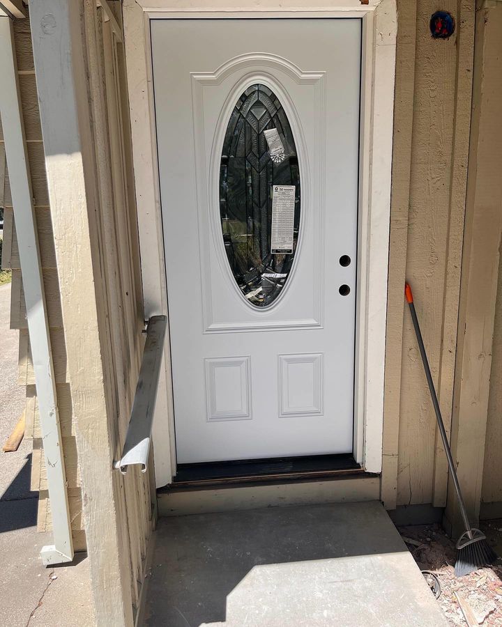 White entry door with oval decorative glass