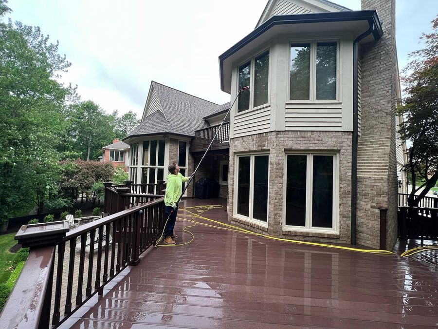 A waterfront home with the deck part way through a ProTech wash