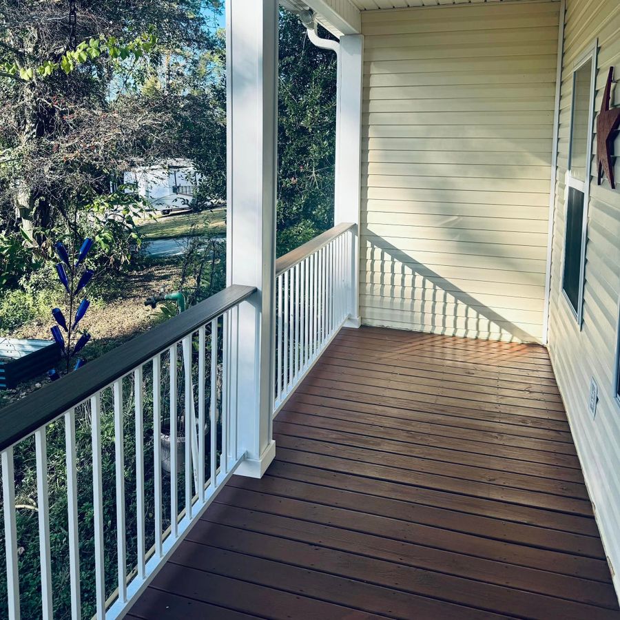 Dark stained porch floor with white rails