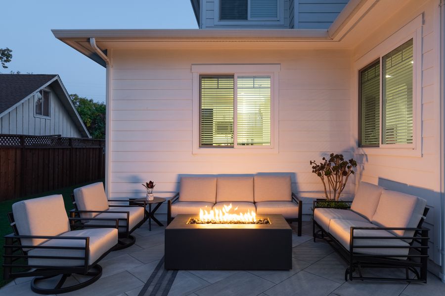 Linear gas fire table alight between lounge sofas at dusk