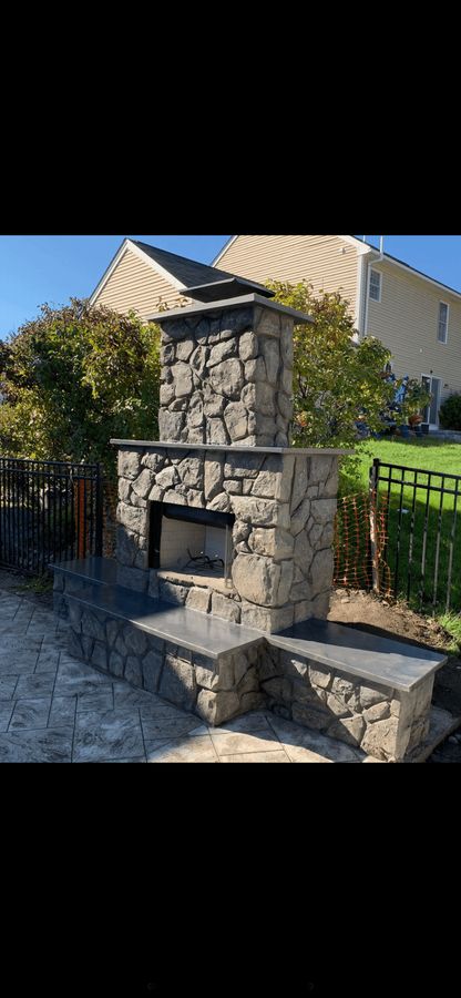 Outdoor fireplace with stone-look hearth benches