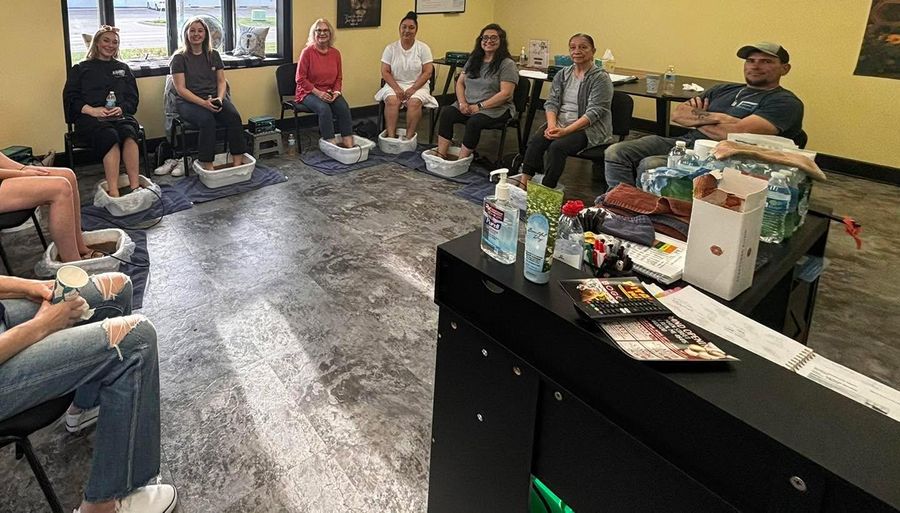 People seated in a circle for a fellowship gathering in the Busy B's office