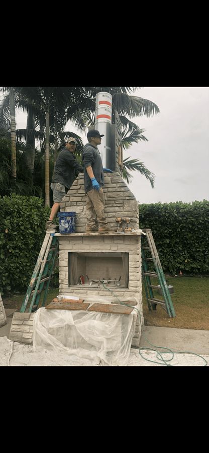Crew building an outdoor fireplace