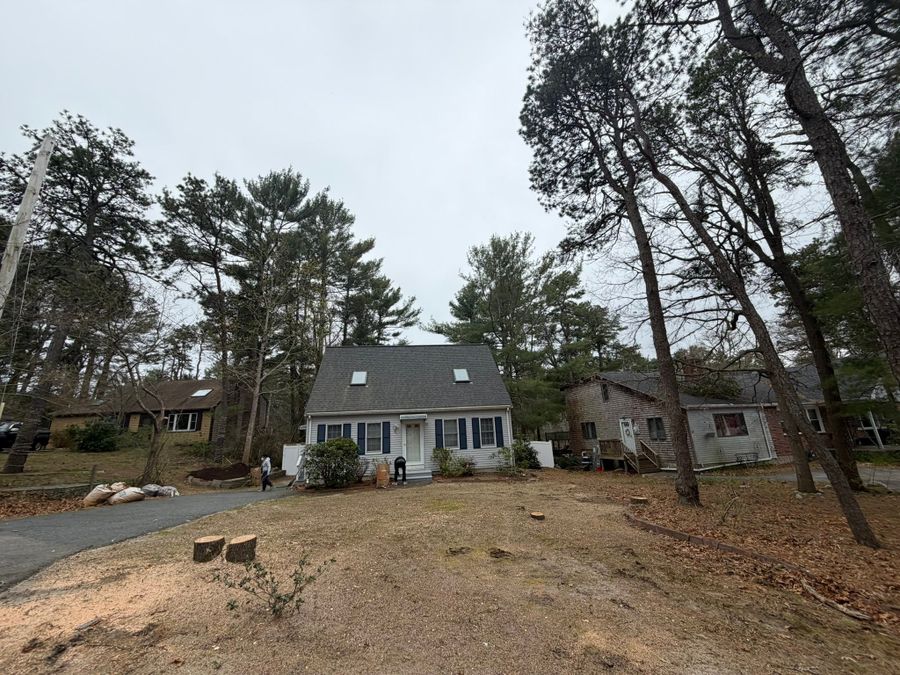 Cape house with fresh stumps in a cleared front yard