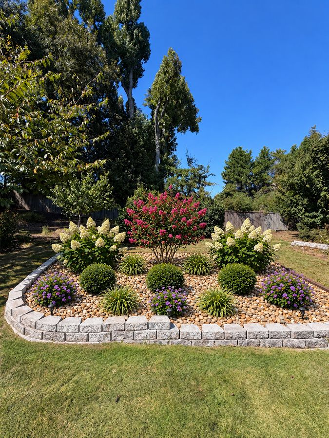 Planted landscape bed with a stone border, a Brody Cleveland project in the Evans, GA area
