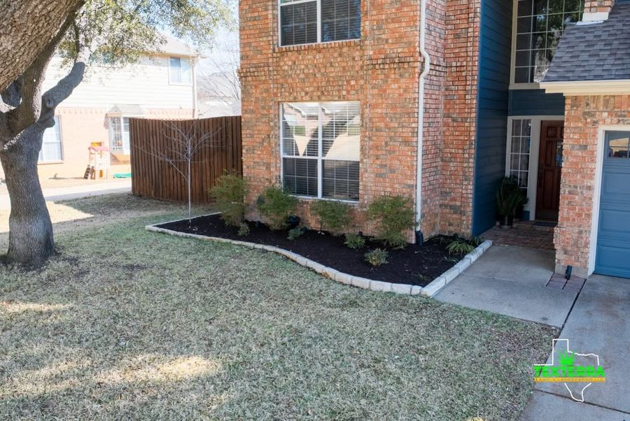 Brick home with newly edged mulch beds