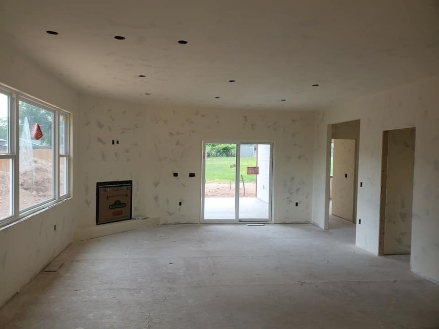 Large room with drywall hung and taped, ready for paint