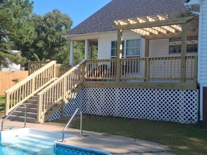 Pool deck with a wood pergola and stairs