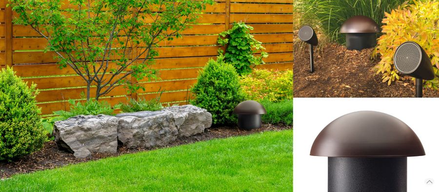 Rock speaker and landscape speakers placed around a backyard stone border