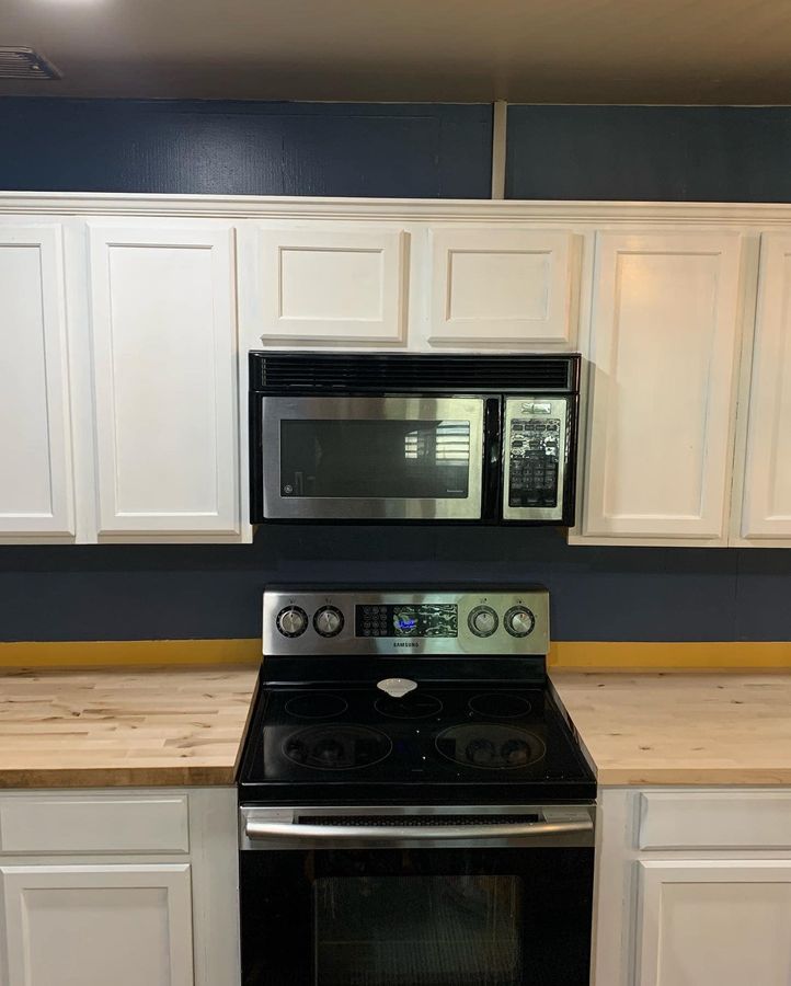 Kitchen with white cabinets and a new range