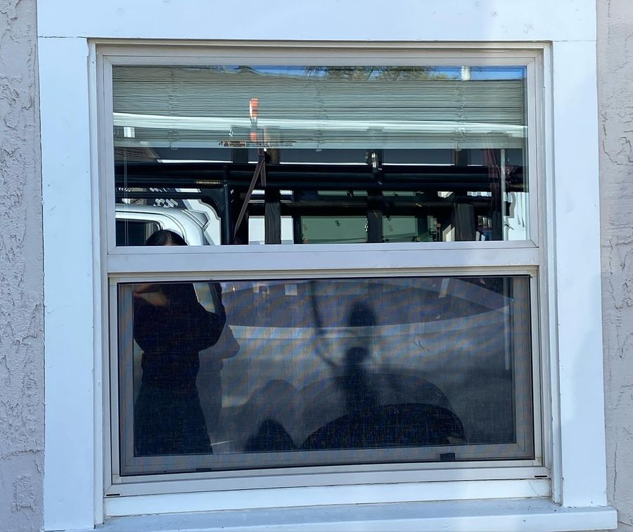 New double-hung window set in a stucco exterior