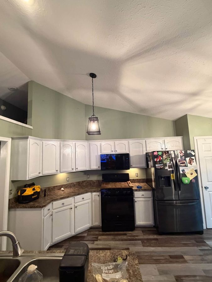 Refinished kitchen cabinets and painted walls with a vaulted ceiling in La Porte County, Indiana