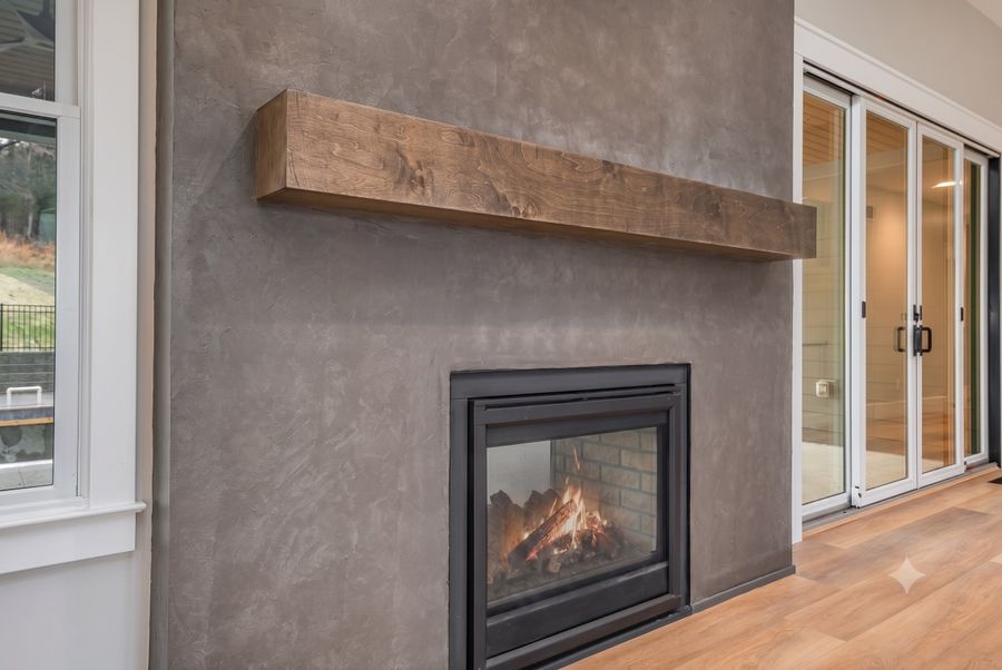 Roman clay fireplace wall with a rustic wood mantel