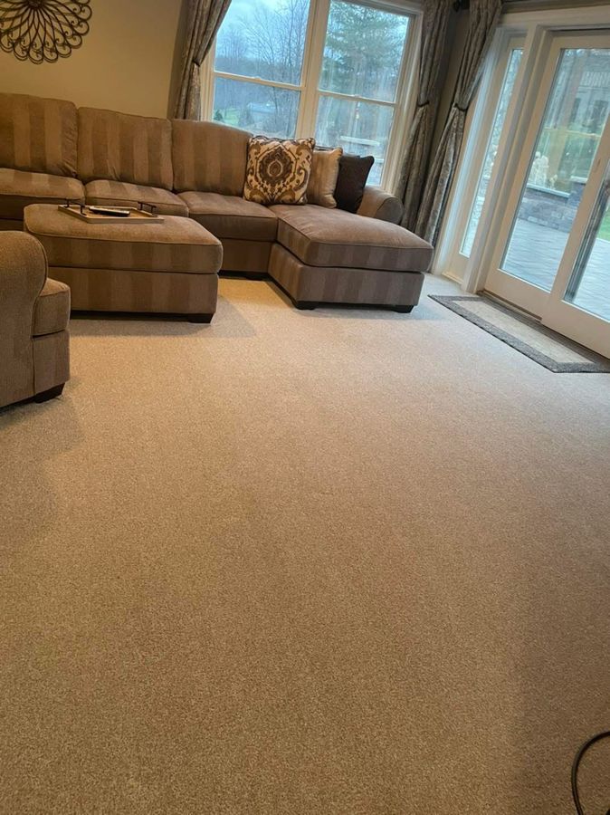 Sectional sofa and freshly vacuumed carpet in a guest-ready rental