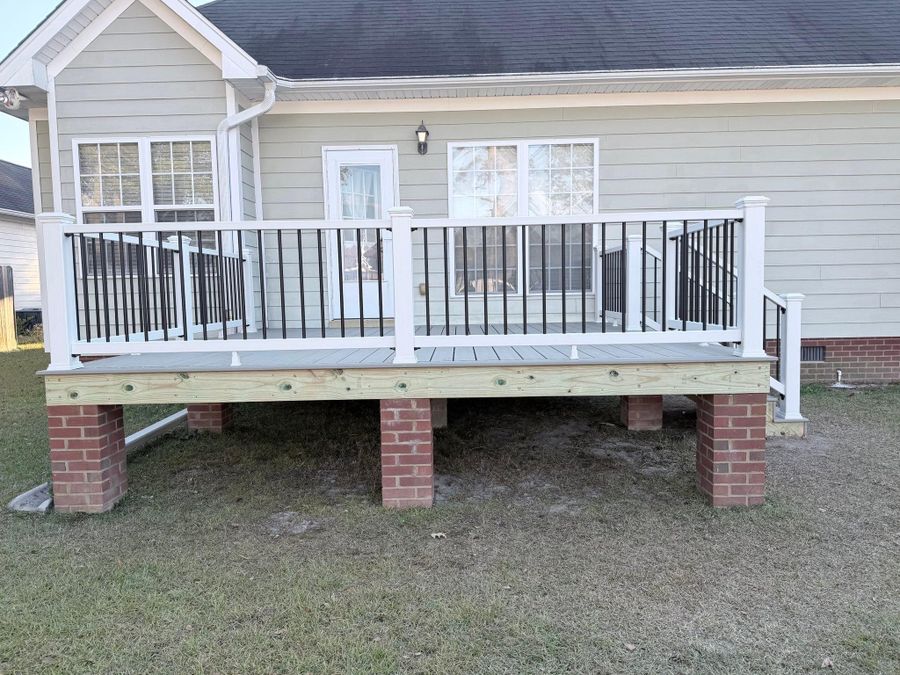 Gray composite deck with white rails, black balusters and wide steps